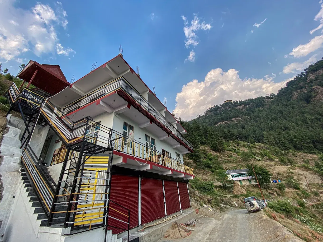 Alpine Crest Homestay exterior on a Himalayan slope near Theog, Himachal Pradesh